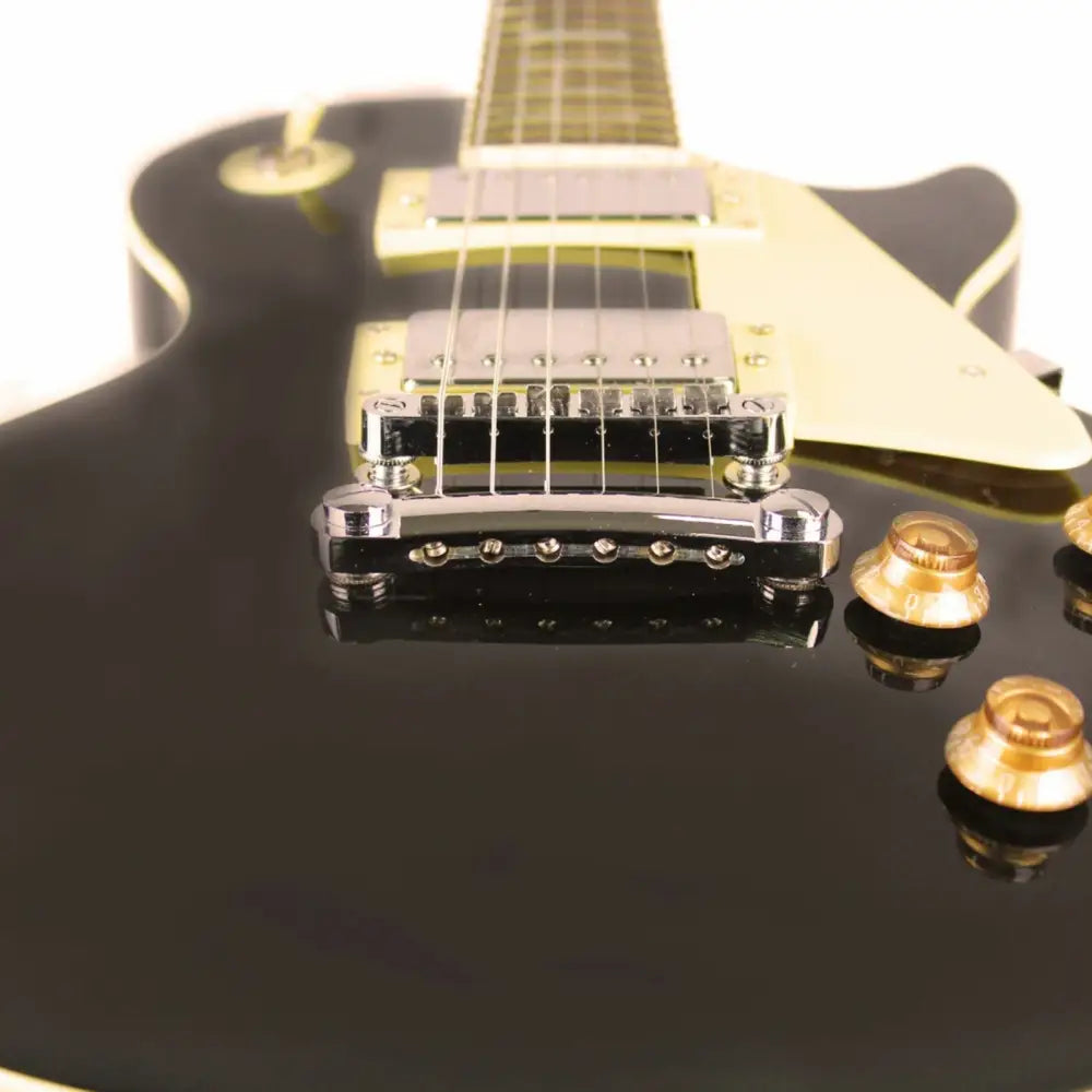 Black electric guitar with chrome hardware and amber knobs, perfect beginner LP style guitar for sale