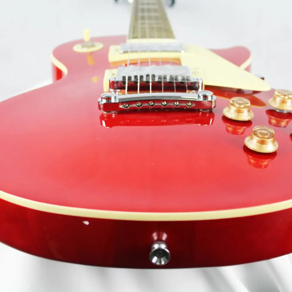Red electric guitar with cream binding, gold knobs, chrome hardware, Challenger Electric Guitar style