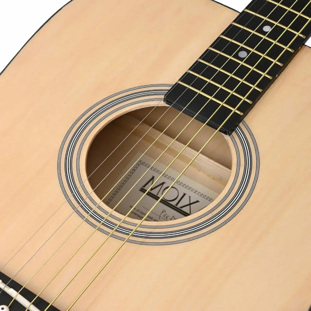 Light-colored wooden left handed acoustic guitar with gold strings perfect for beginners in Australia