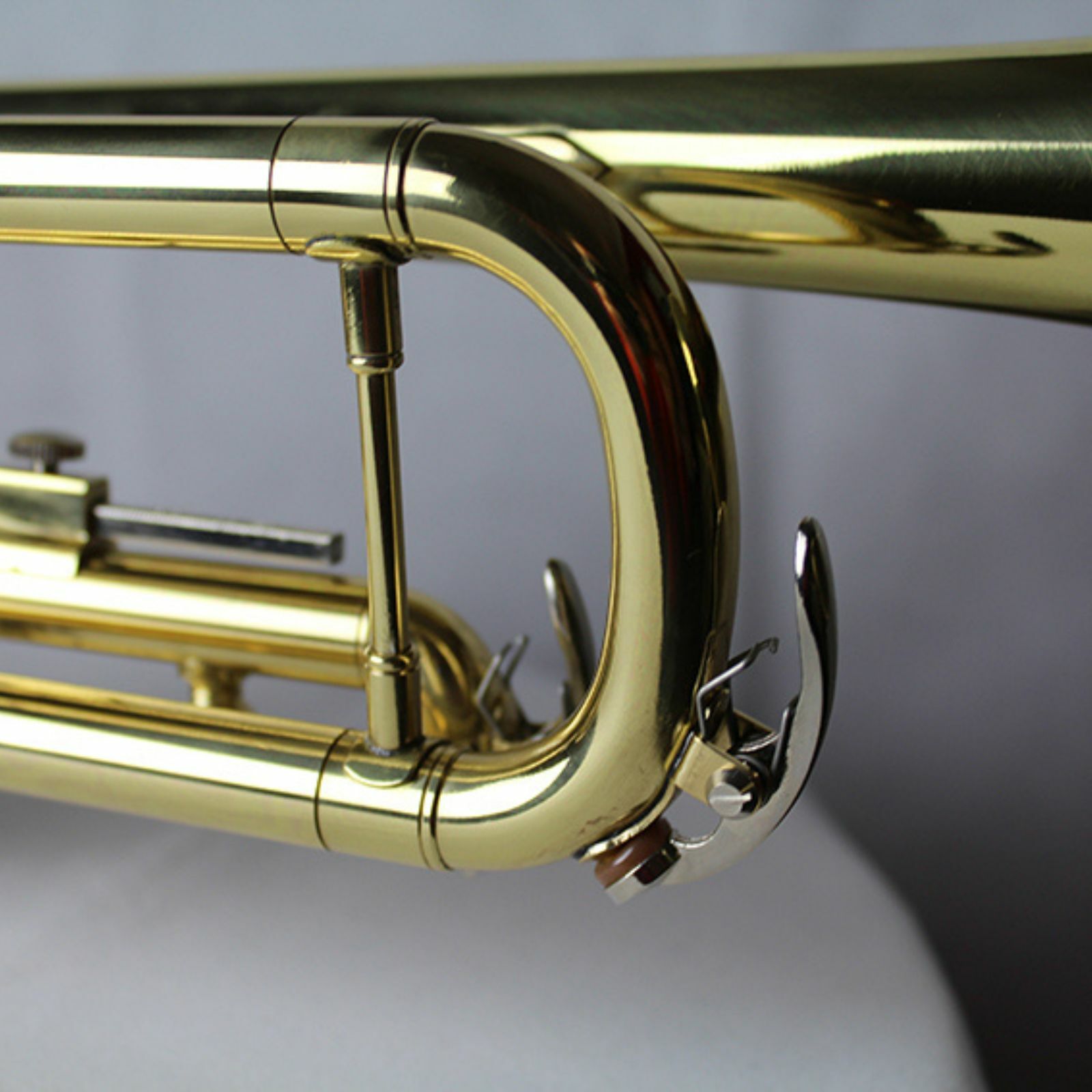 The Axiom Prelude Trumpet Outfit - School Band by Axiom Music includes a yellow brass body, three valves, and a silver mouthpiece, shown on a white background for easy playability.