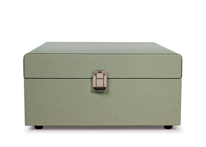 The Crosley Voyager Sage Bluetooth Portable Turntable by Crosley is shown with the lid open, playing a vinyl record. The front panel includes a speaker grille, control knobs, and RCA outputs for easy connectivity.