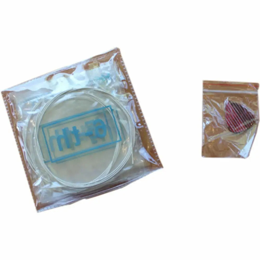 Guitar strings and pick in plastic packaging for beginner guitar pack, nylon string guitar