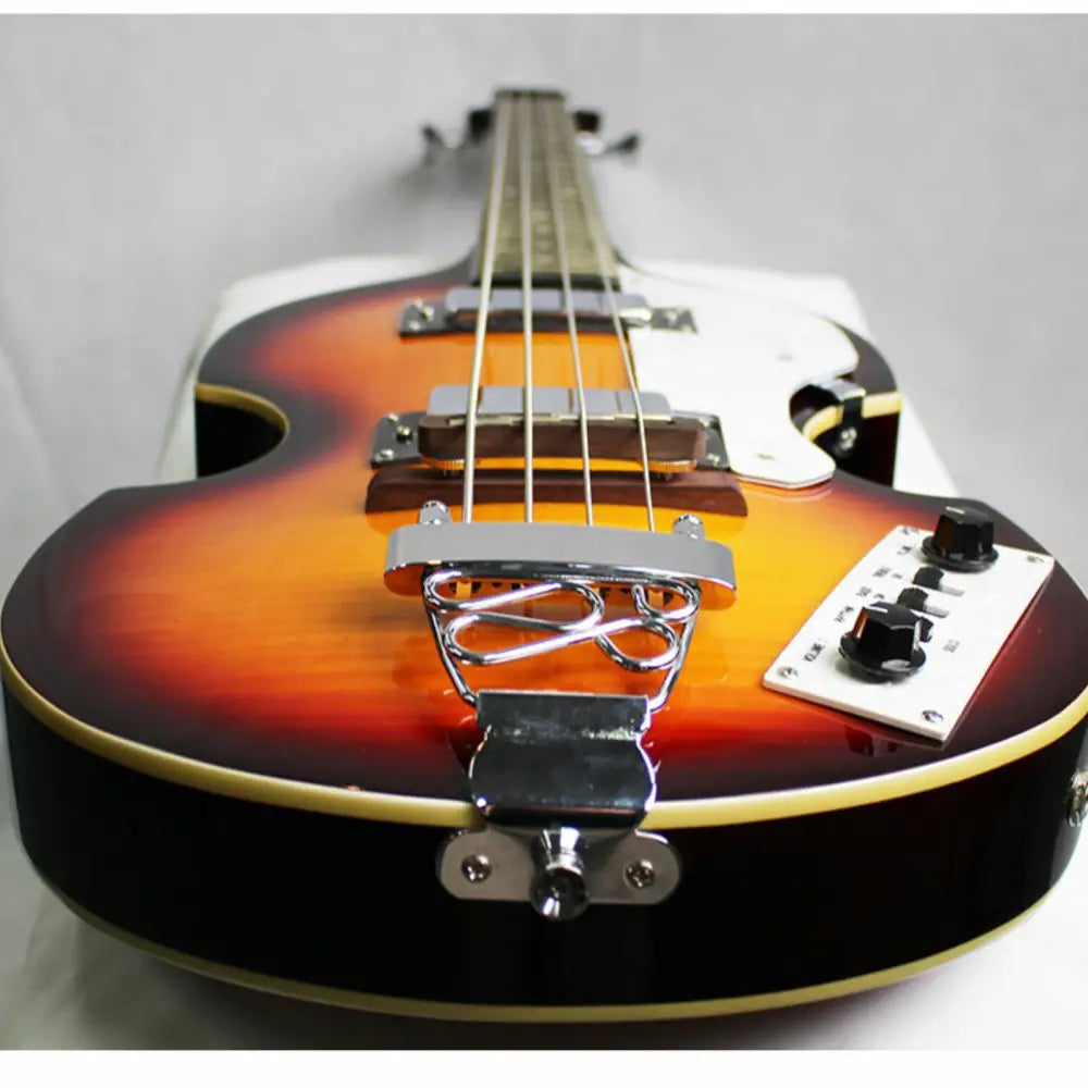 Axiom Cavern Beatle Bass hollow-body bass guitar with sunburst finish and trapeze tailpiece