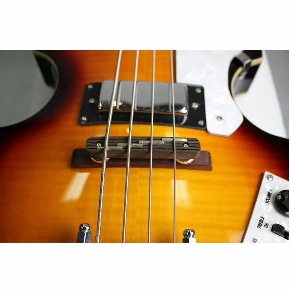 Close-up of Axiom Cavern Beatle Bass body with strings bridge and pickups for cavern bass style
