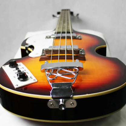 Left handed Axiom Cavern Beatle Bass with sunburst finish, white pickguard, chrome hardware