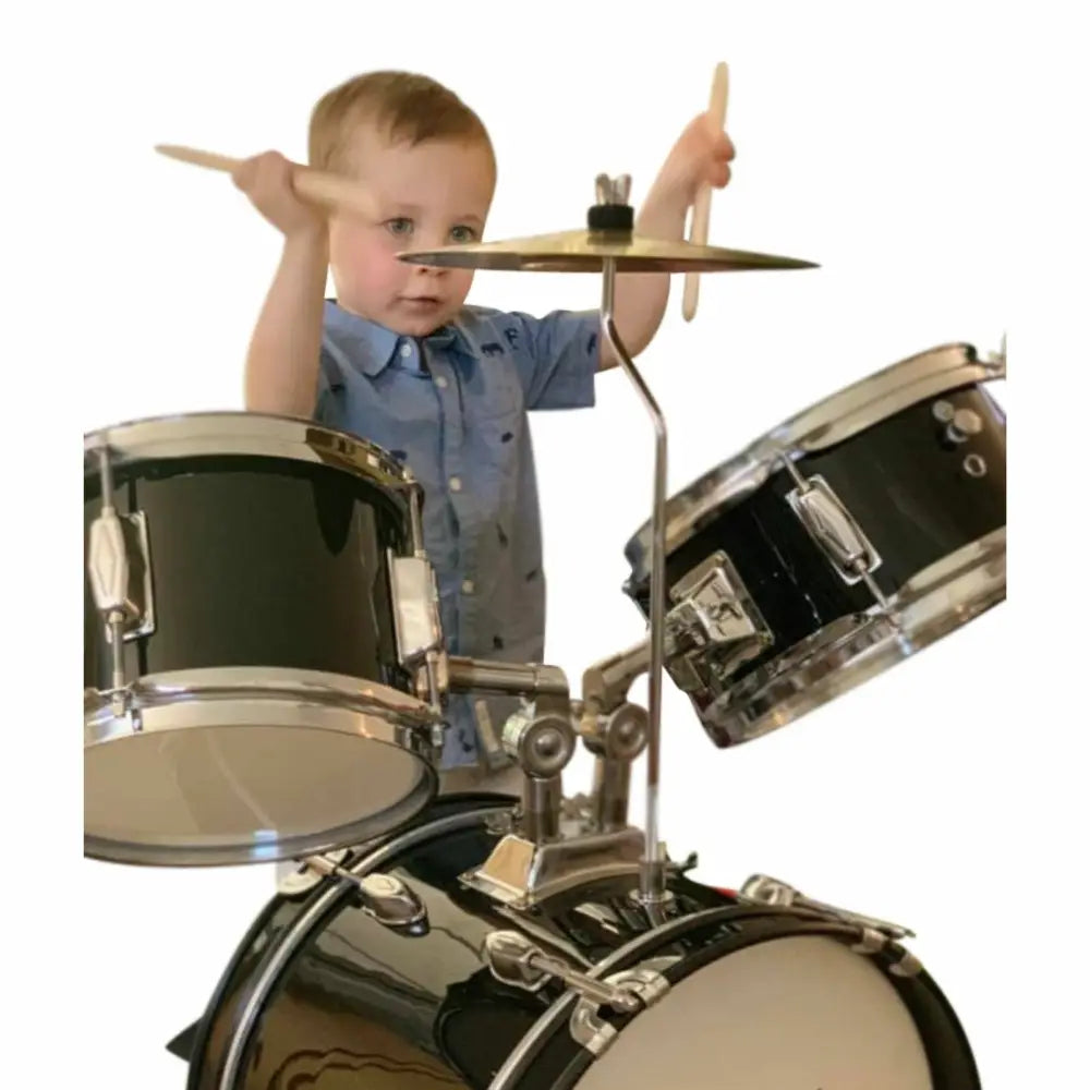 Young kid playing Axiom Kids Drum Set with drumsticks, perfect toddler drum set for children
