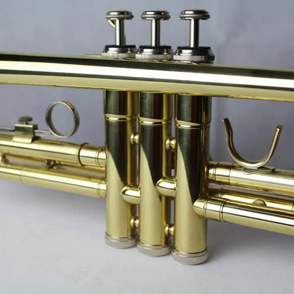 Golden brass trumpet valves and slides of the Axiom Prelude Trumpet Outfit for school band