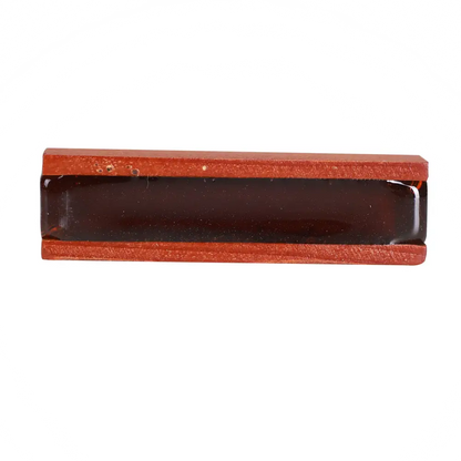 Red leather-bound rectangular box with dark glossy interior for axiom violin rosin storage and protection