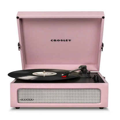 Pink Crosley Voyager Amethyst portable turntable with built-in Bluetooth and vinyl record