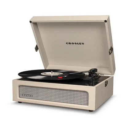 Cream-colored Crosley Voyager Dune Bluetooth portable turntable with open lid and vinyl