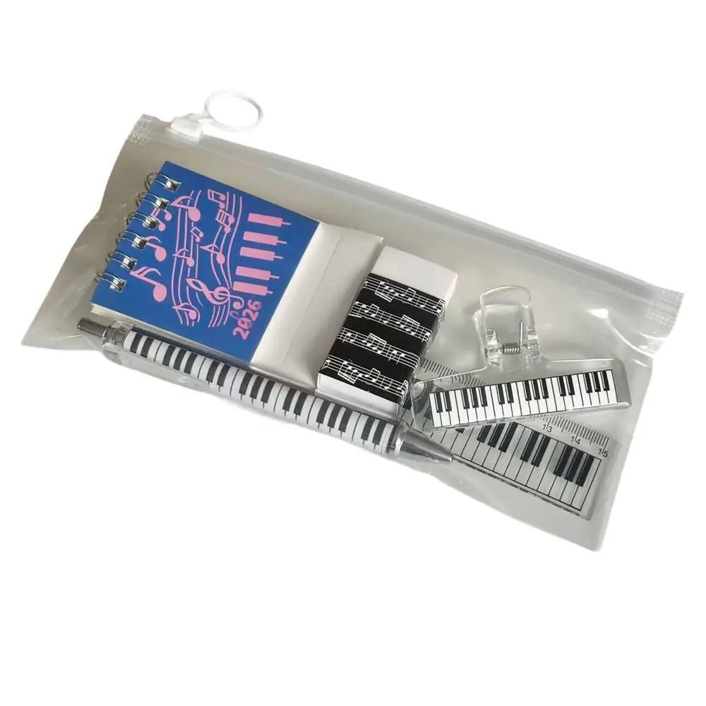 Blue spiral notebook with pink musical notes and 2026 print in a musical stationery gift set with piano keyboard design
