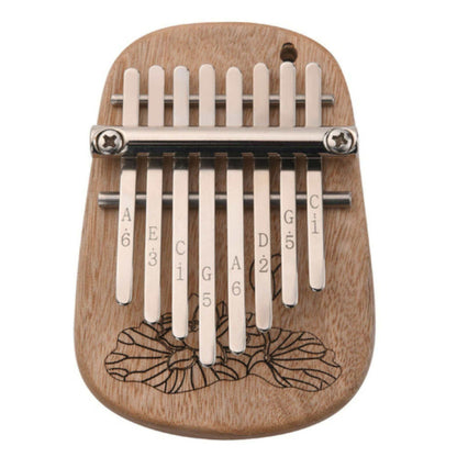 The Axiom Kalimba Thumb Piano by Axiom Music is crafted from camphor wood with an engraved floral design, labeled metal tines for notes and numbers, and comes with a tuning hammer for easy adjustments.