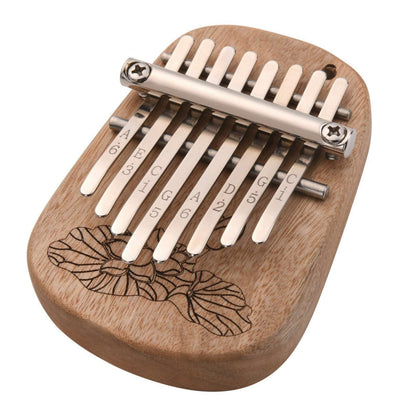 The Axiom Kalimba Thumb Piano by Axiom Music is crafted from camphor wood with an engraved floral design, labeled metal tines for notes and numbers, and comes with a tuning hammer for easy adjustments.