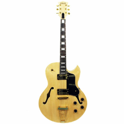 The Axiom Music Columbia Archtop Electric Guitar - Natural features a hollow body, black and gold hardware, f-hole, rectangular fretboard inlays, and vintage-style humbuckers.