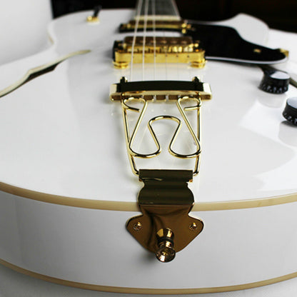 The Axiom Music Axiom Columbia Archtop Electric Guitar White Bird features a white hollow body, gold hardware, black pickguard, vintage-style humbuckers, four knobs, two pickups, and f-hole cutouts.
