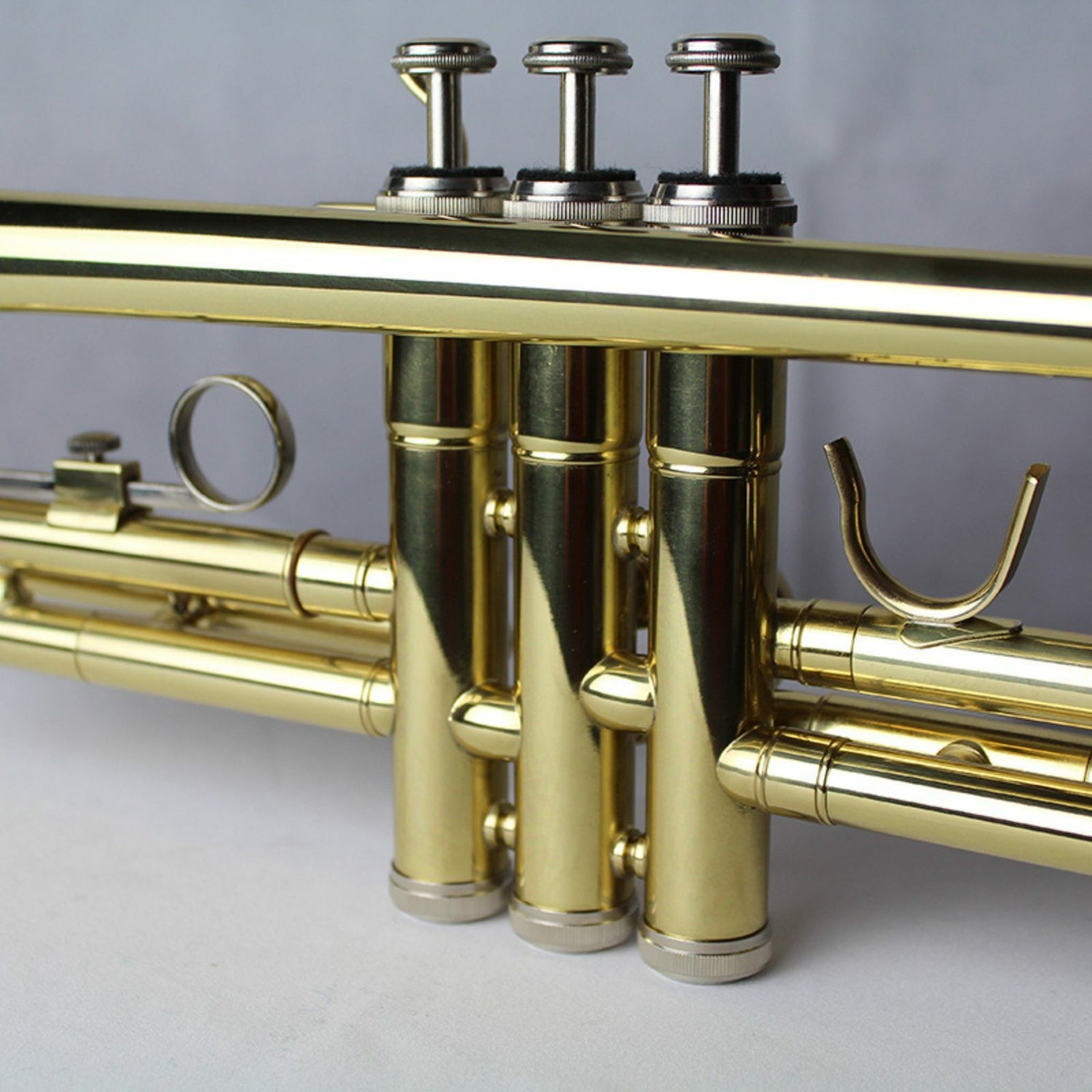 The Axiom Prelude Trumpet Outfit - School Band by Axiom Music includes a yellow brass body, three valves, and a silver mouthpiece, shown on a white background for easy playability.
