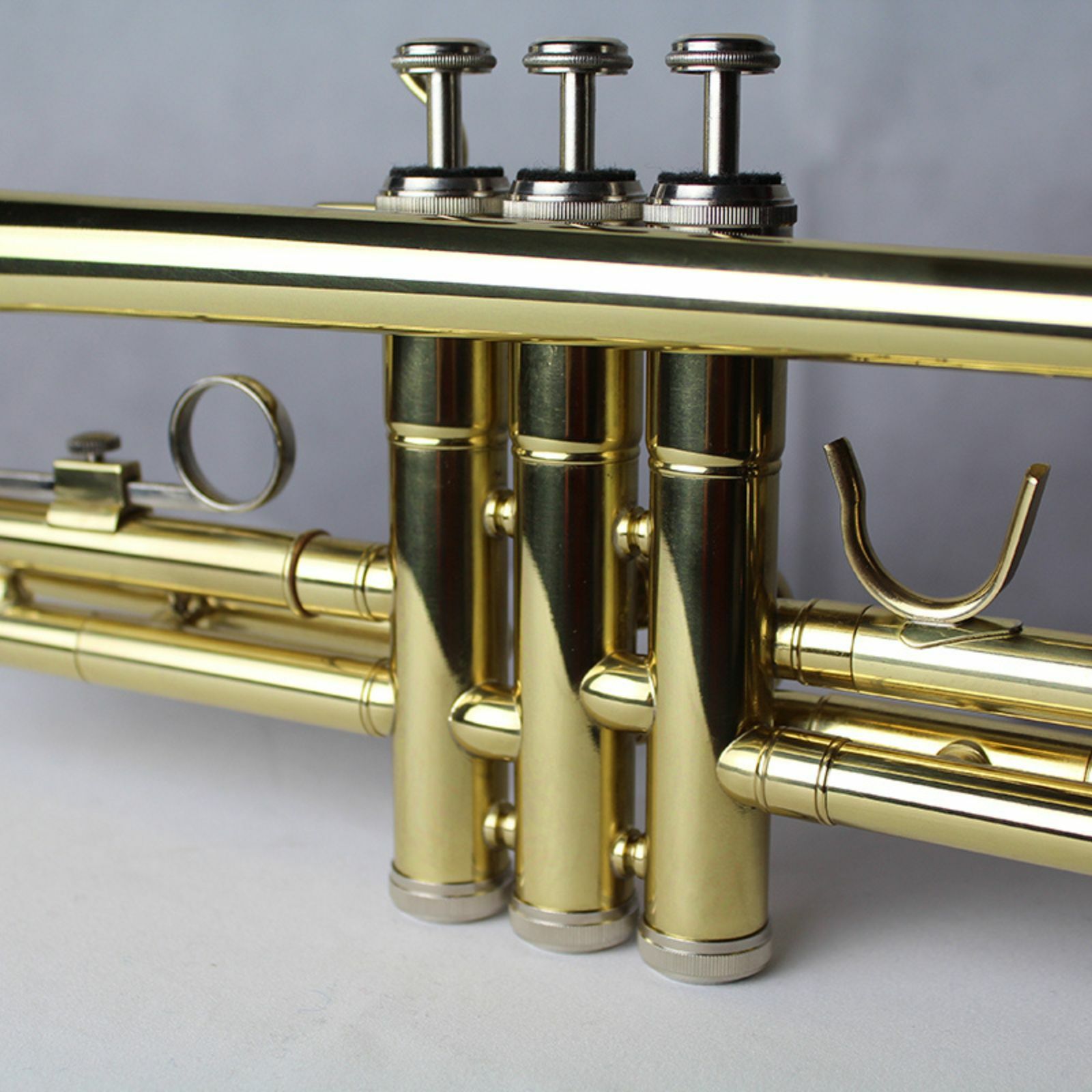 The Axiom Prelude Trumpet Outfit - School Band by Axiom Music includes a yellow brass body, three valves, and a silver mouthpiece, shown on a white background for easy playability.