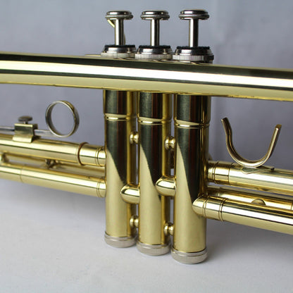 The Axiom Prelude Trumpet Outfit - School Band by Axiom Music includes a yellow brass body, three valves, and a silver mouthpiece, shown on a white background for easy playability.